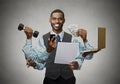 Multitasking happy business man on grey wall background