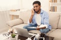 Serious man talking on phone and reading document Royalty Free Stock Photo