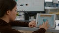 Multitasking paralyzed project manager zoom in on tablet checking project