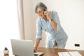 Multitasking senior businesswoman on a phone call Royalty Free Stock Photo