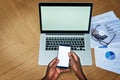 Multitasking the technological way. High angle shot of an unrecognizable businessperson texting on their cellphone while Royalty Free Stock Photo