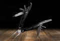 Multitool knife on a dark background. Royalty Free Stock Photo