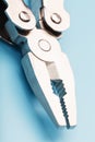 The multitool multi-function tool hovers on a blue background. The concept of an expanded multi-tool with free space