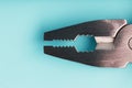 The multitool multi-function tool hovers on a blue background. The concept of an expanded multi-tool with free space
