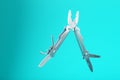 The multitool multi-function tool hovers on a blue background. The concept of an expanded multi-tool with free space