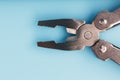 The multitool multi-function tool hovers on a blue background. The concept of an expanded multi-tool with free space