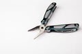 Multitool with pliers on white background. Top view. Tools for cutting, sawing, screwing, compressing and other