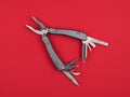 Multitool on a red background closeup Royalty Free Stock Photo