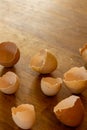 A multitude of broken egg shells on a oak wooden desk. Picture made in the kitchen with natural lighting Royalty Free Stock Photo