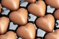 Multitude of heart-shaped milk chocolate in their box