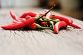 Multitude of red chili peppers on wooden table