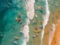 multitude of surfers in the sea seen from above, aerial image of the sea with colored surf in the waves, holidays, created with ai Royalty Free Stock Photo