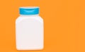 multivitamin bottle on yellow background. copy space. food supplement.