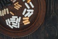 Multivitamin pills on a clay plate, on a vintage wooden table