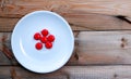 multivitamin pills white plate on on wood background