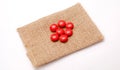 multivitamin red pills on a jute bag background Royalty Free Stock Photo