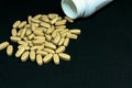 Multivitamin tablets sprinkled and a pills bottle . Selective focus Royalty Free Stock Photo