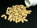 Multivitamin tablets sprinkled and a pills bottle . Selective focus Royalty Free Stock Photo