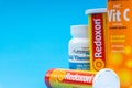 Multivitamin tablets and Vitamin C container closeup. Royalty Free Stock Photo
