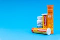 Multivitamin tablets and Vitamin C container closeup. Royalty Free Stock Photo