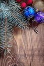 Multycolored christmas balls with pinetree branch on old wooden