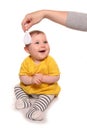 Mum combing baby girls hair