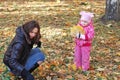 Mum with a daughter walk in autumn