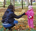 Mum with a daughter walk in autumn park Royalty Free Stock Photo