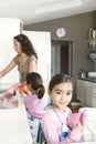 Mum and Daughters Washing Up In Kitchen Royalty Free Stock Photo