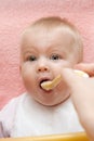 Mum feeds with a spoon her small daughter Royalty Free Stock Photo