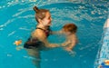 Mum learns kid to float in pool Royalty Free Stock Photo