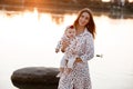 Mum, little daughter outdoors. Young mother with baby girl walk on beach near lake on sunset. Family holiday on pond. Portrait mom Royalty Free Stock Photo