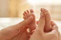 Mum making baby massage, mother massaging infant bare foot, preventive massage for newborn, mommy stroking the baby`s feet with Royalty Free Stock Photo