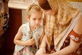 Mum and daughter sit on bench in Church Orthodox