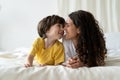 Mum and son bonding lying in bed. Happy loving mom and small child enjoy morning together on weekend Royalty Free Stock Photo