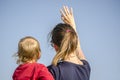 Mum and son waving Royalty Free Stock Photo