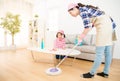 Mum teaching daughter cleaning home