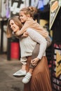 mum and teenage daughter having fun on a walk in the city. Royalty Free Stock Photo