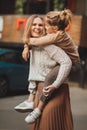 mum and teenage daughter having fun on a walk in the city. Royalty Free Stock Photo