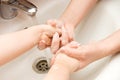 Mum washes hands to the child Royalty Free Stock Photo