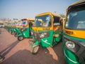 Mumbai, India - December 17, 2019: Yellow and green auto rickshaws in Indiya.