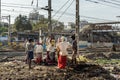 Indian workers carrying basin with ground head near Suburban Railway in Dharavi Slum at Mumbai. India Royalty Free Stock Photo