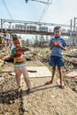 Indian young boys eating near Suburban Railway in Dharavi Slum at Mumbai. India Royalty Free Stock Photo