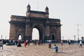 Tourists gather at the Gateway of India in the morning at the famous arch tower
