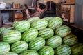 Mumbai, India - February 29, 2020: Vendor selling fruit watermelon looks bored as he checks his cell phone at Crawford Market,