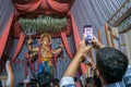 A man clicking a picture of Lord Ganesha