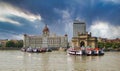 Mumbai, India: Wide angle shot of Gateway of India and Taj hotel against sea and dramatic cloudy sky Royalty Free Stock Photo