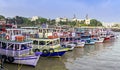 Mumbai, Maharashtra, India - April 19th, 2022 : Colorful ferry boats lined up at Gateway of India port in Mumbai