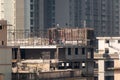 Mumbai, Maharashtra, India - January 2021: A building under construction in a dense, high rise residential neighbourhood in the