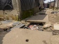 Open gutter sewer line in slum area of Mumbai, India.